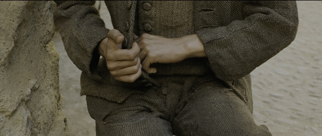 Wide shot frame from Perfume: The Story of a Murderer — person, human hand, trousers