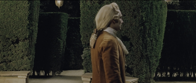 Wide shot frame from Perfume: The Story of a Murderer — standing, hat, coat