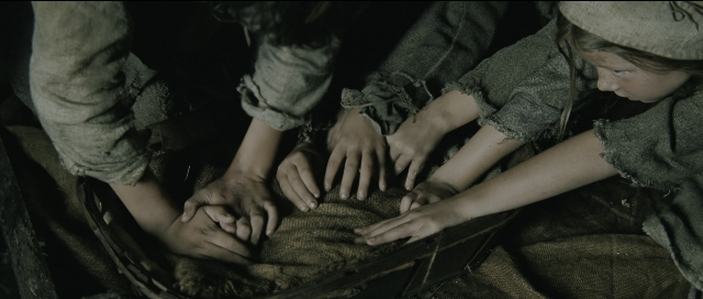 Wide shot frame from Perfume: The Story of a Murderer — person, human face, human hand