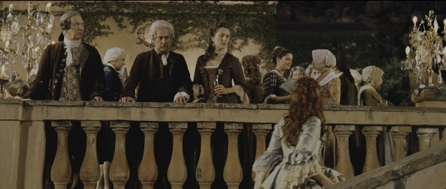 Wide shot frame from Perfume: The Story of a Murderer — standing, suit, dress