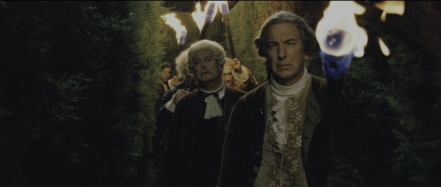 Wide shot frame from Perfume: The Story of a Murderer — standing, hat, suit