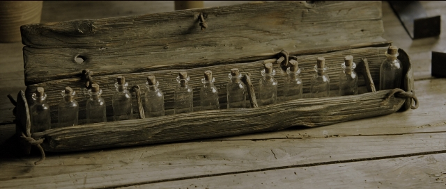 Wide shot frame from Perfume: The Story of a Murderer — room, bottle, glass