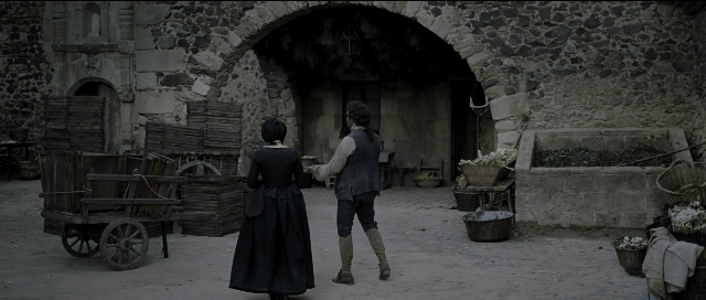 Wide shot frame from Perfume: The Story of a Murderer — walking, dialogue, hat