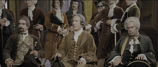 Wide shot frame from Perfume: The Story of a Murderer — sitting, book, standing
