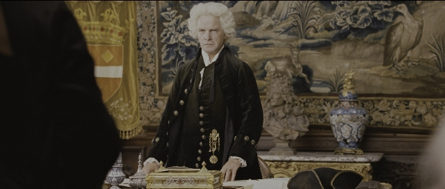 Wide shot frame from Perfume: The Story of a Murderer — sitting, book, room
