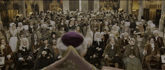Wide shot frame from Perfume: The Story of a Murderer — sitting, standing, hat