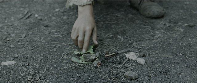 Wide shot frame from Perfume: The Story of a Murderer — hand, person, footwear