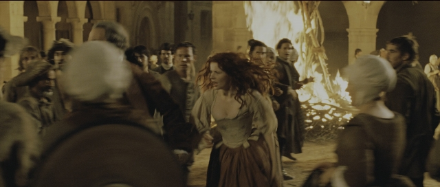 Wide shot frame from Perfume: The Story of a Murderer — standing, fire, dress