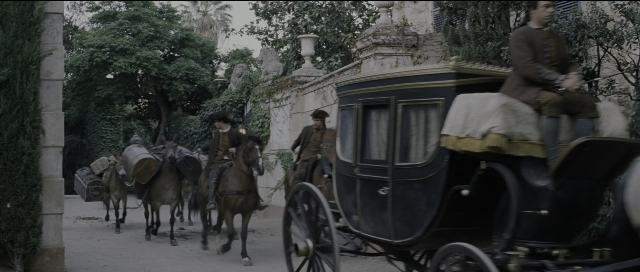 Wide shot frame from Perfume: The Story of a Murderer — sitting, street, hat