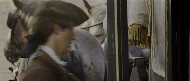 Wide shot frame from Perfume: The Story of a Murderer — hat, shirt, horse
