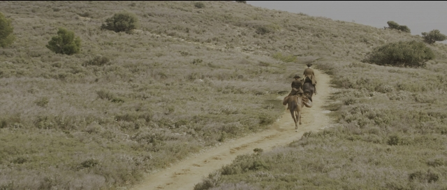 Wide shot frame from Perfume: The Story of a Murderer — walking, animal, street
