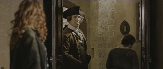 Wide shot frame from Perfume: The Story of a Murderer — sitting, standing, mirror