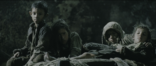 Wide shot frame from Perfume: The Story of a Murderer — standing, bed, face