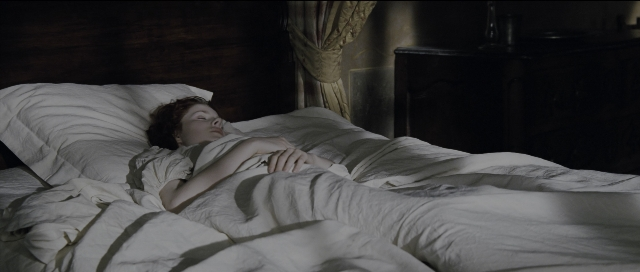 Wide shot frame from Perfume: The Story of a Murderer — bed, person, human face