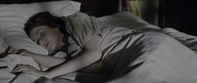 Wide shot frame from Perfume: The Story of a Murderer — bed, dress, hair