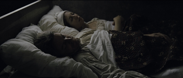 Wide shot frame from Perfume: The Story of a Murderer — bed, dress, hair