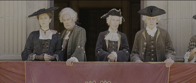 Wide shot frame from Perfume: The Story of a Murderer — standing, door, hat