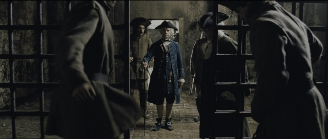Wide shot frame from Perfume: The Story of a Murderer — standing, hat, coat