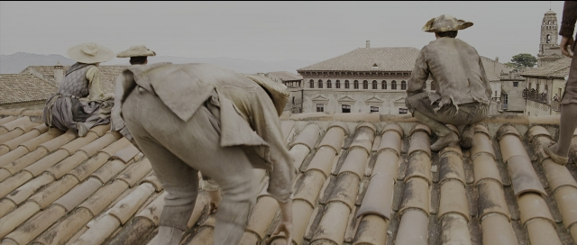 Wide shot frame from Perfume: The Story of a Murderer — standing, clock, person