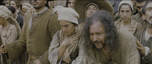 Wide shot frame from Perfume: The Story of a Murderer — book, beard, hair