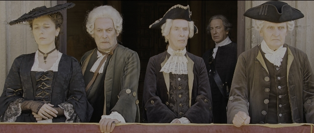 Wide shot frame from Perfume: The Story of a Murderer — standing, hat, suit