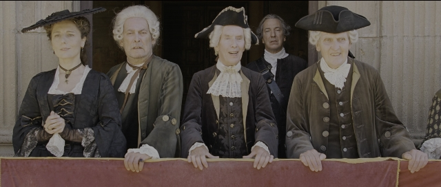 Wide shot frame from Perfume: The Story of a Murderer — standing, hat, suit