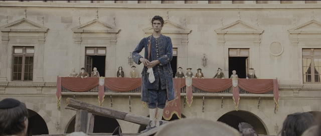 Wide shot frame from Perfume: The Story of a Murderer — standing, coat, hand