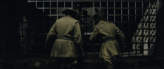 Wide shot frame from Perfume: The Story of a Murderer — walking, room, coat