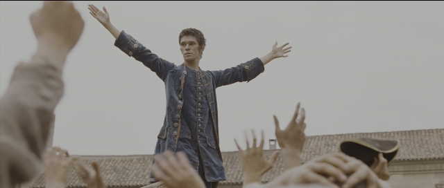 Wide shot frame from Perfume: The Story of a Murderer — standing, coat, face