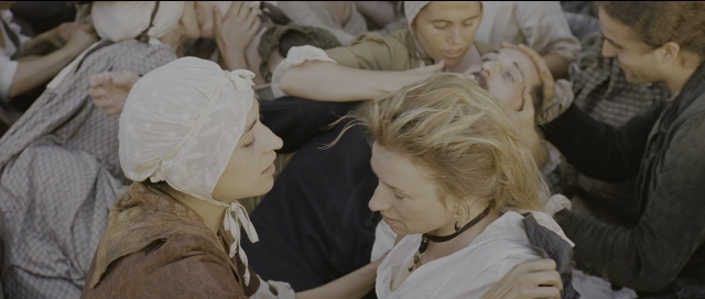 Wide shot frame from Perfume: The Story of a Murderer — sitting, dress, person