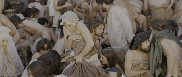 Wide shot frame from Perfume: The Story of a Murderer — sitting, book, bed