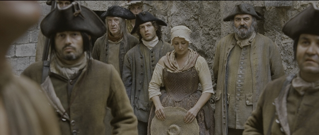 Wide shot frame from Perfume: The Story of a Murderer — standing, hat, coat