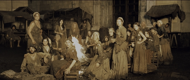 Wide shot frame from Perfume: The Story of a Murderer — sitting, standing, person