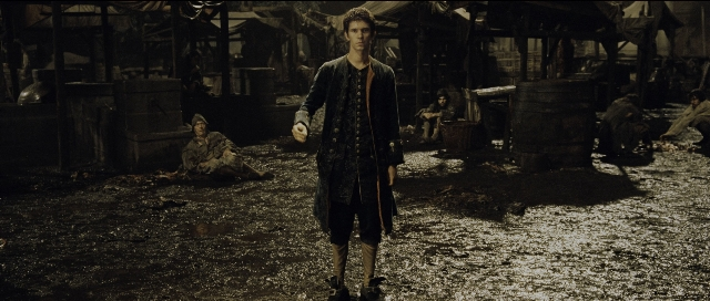 Wide shot frame from Perfume: The Story of a Murderer — standing, room, coat