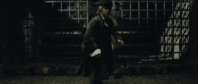 Wide shot frame from Perfume: The Story of a Murderer — walking, hat, coat