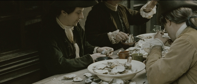 Wide shot frame from Perfume: The Story of a Murderer — sitting, plate, table