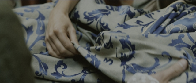 Wide shot frame from Perfume: The Story of a Murderer — person, human hand