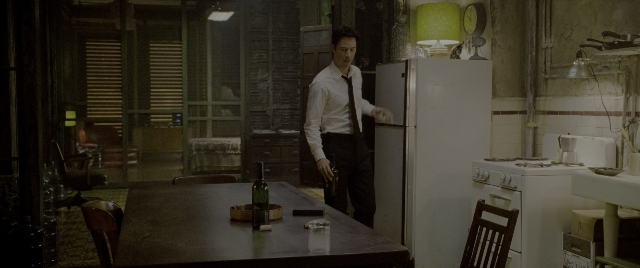 Wide shot frame from Constantine — standing, table, kitchen