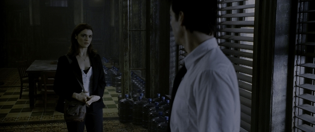 Wide shot frame from Constantine — standing, room, coat