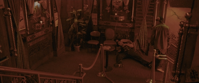 Wide shot frame from Constantine — sitting, room, table