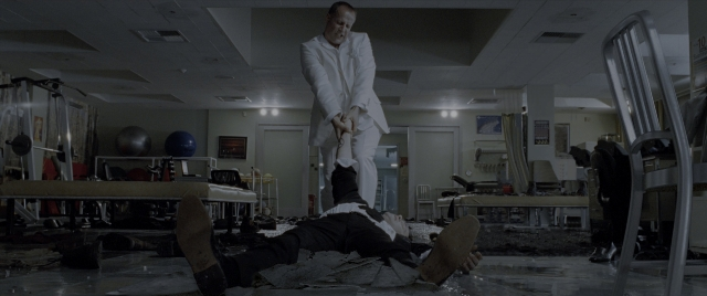 Wide shot frame from Constantine — standing, room, coat