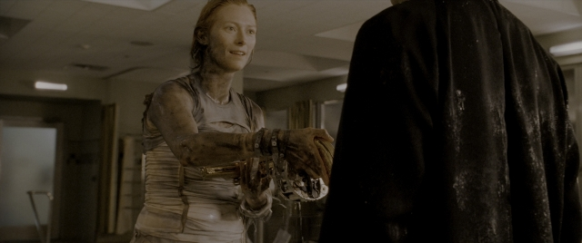 Wide shot frame from Constantine — standing, room, hand