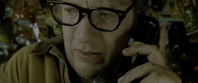 Wide shot frame from Constantine — room, phone, beard