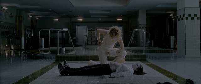 Wide shot frame from Constantine — standing, room, shirt