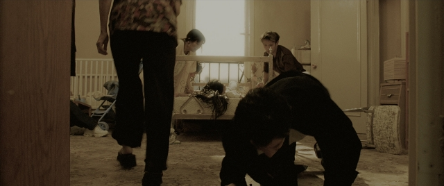 Medium shot frame from Constantine — sitting, standing, room