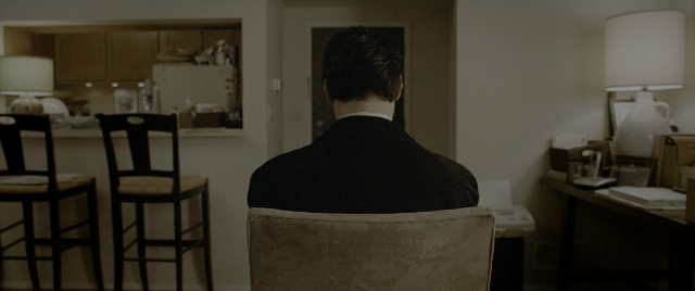 Wide shot frame from Constantine — sitting, room, table