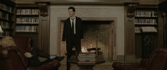 Wide shot frame from Constantine — sitting, book, standing