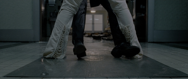 Wide shot frame from Constantine — standing, room, door