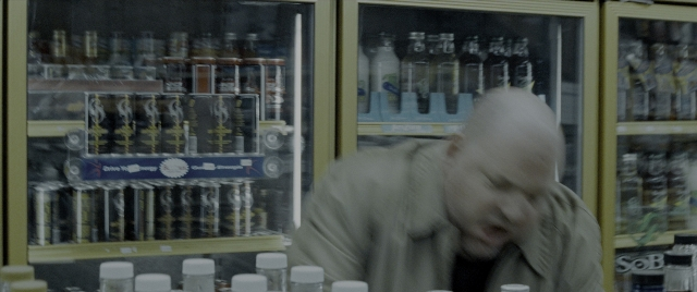 Wide shot frame from Constantine — standing, drink, bottle