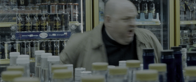 Wide shot frame from Constantine — standing, bottle, face